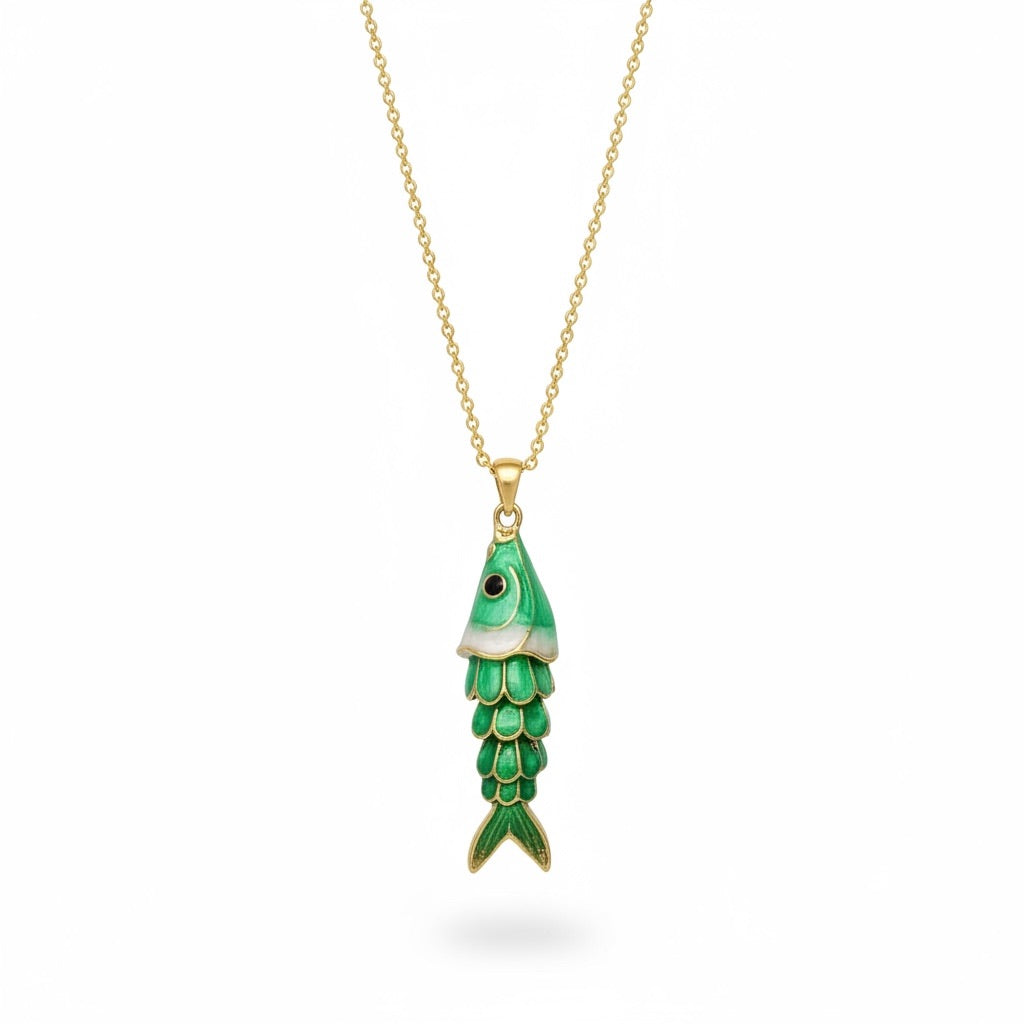 A gold chain necklace with a fish-shaped pendant featuring green enamel scales and a small black eye, shown on a plain white background.