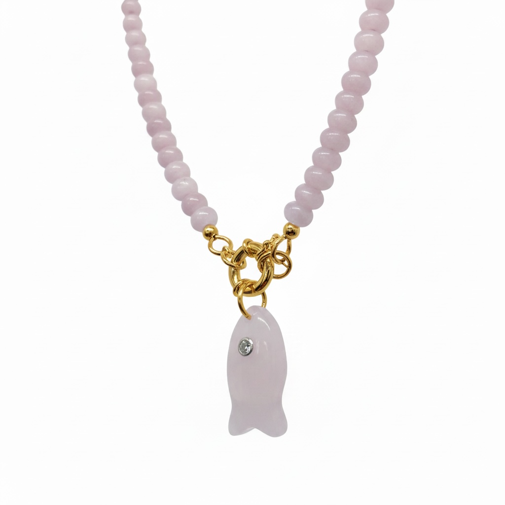 A pink beaded necklace with a gold clasp and a pink fish-shaped pendant featuring a small clear rhinestone, shown against a plain white background.