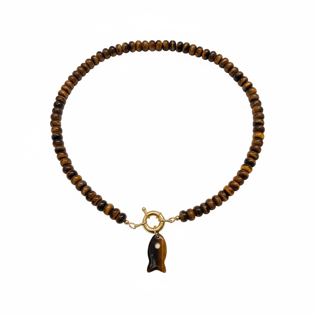A beaded bracelet made of brown and black tiger's eye beads, featuring a gold-tone toggle clasp and a dangling fish charm with a white eye detail, set against a plain white background.