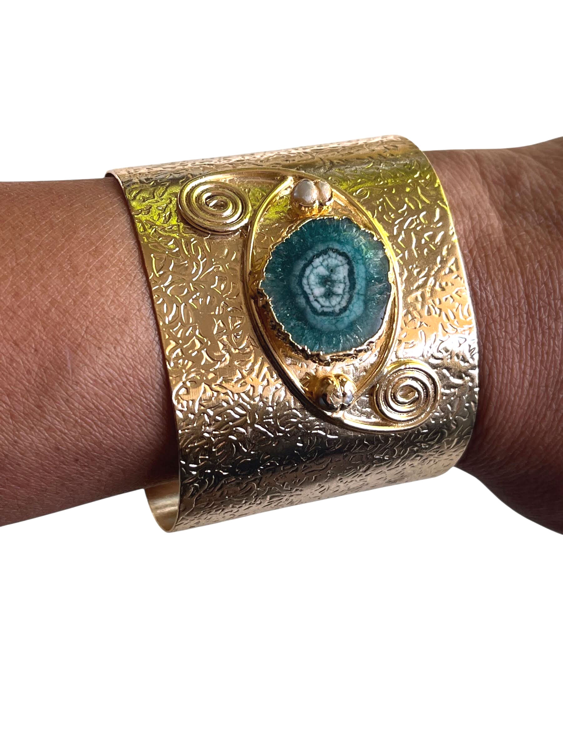 Model wearing Decenarios Cool luxury adjustable bracelet, 24K gold plated brass with irregular green agate stone and Ionian Volutes 