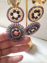 Load image into Gallery viewer, Boho Chic Handwoven Earrings in purple. Hand holding earring.
